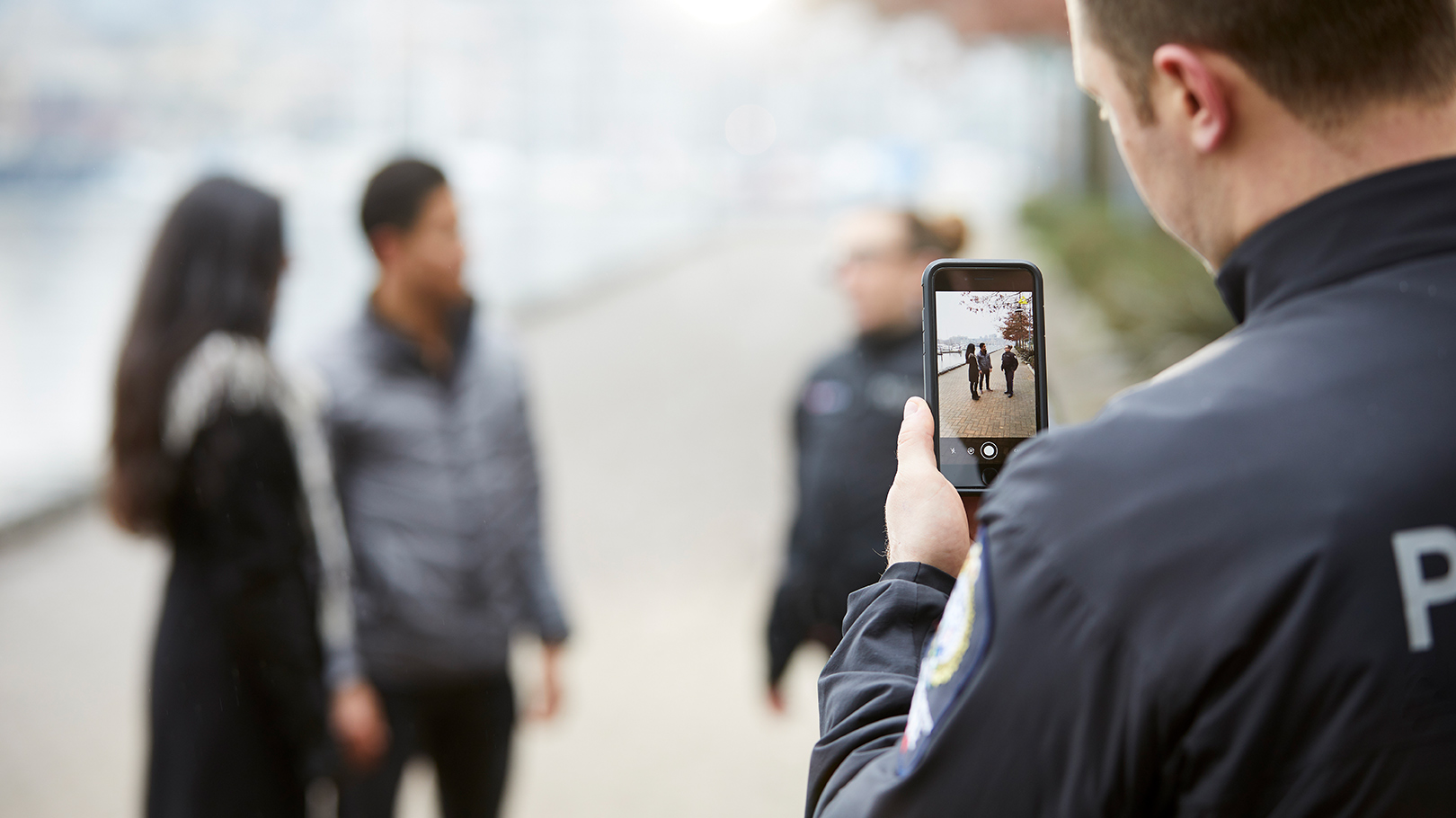 An officer gathers evidence using Axon Capture, a smartphone application